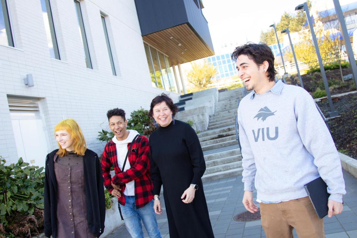 Four people walk down the stairs next to the Health and Science Centre at VIU's Nanaimo campus