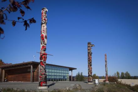 Three totems in front of Shq'apthut, VIU's Gathering Place