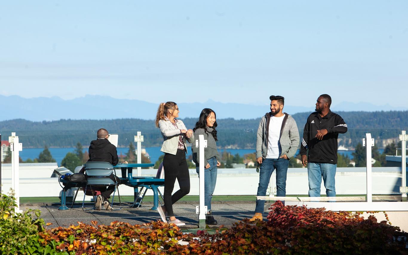 Students on rooftop with ocean in background